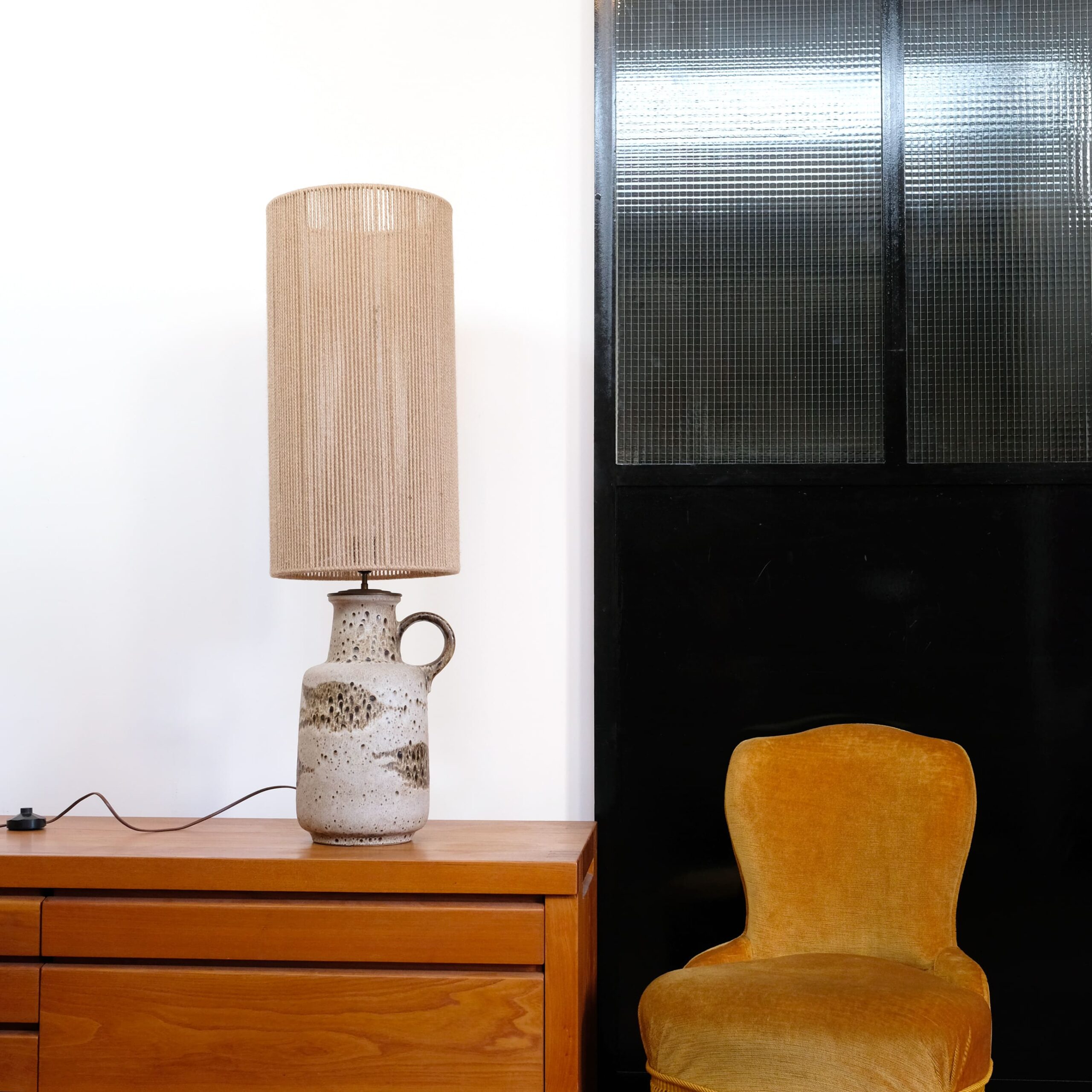Large ceramic table lamp with its rope shade.